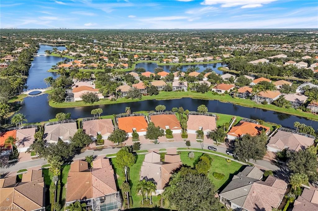3333 Cayman Lane Naples, FL 34119 - Photo 35 of 43 an aerial view of a city with lots of residential buildings and ocean view in back
