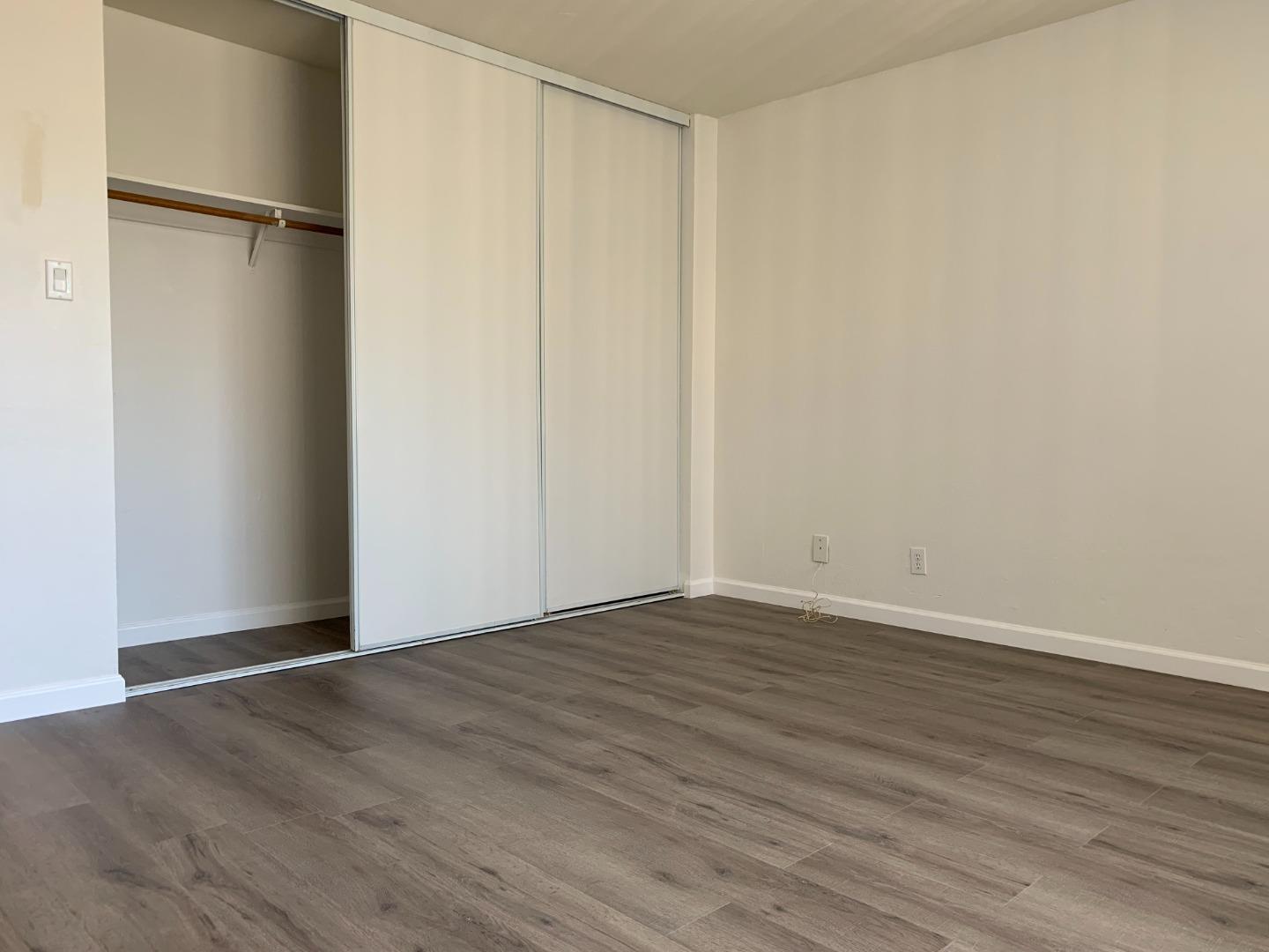 729 Highland Avenue, Unit 3 San Mateo, CA 94401 - Photo 16 of 18 a view of an empty room with wooden floor