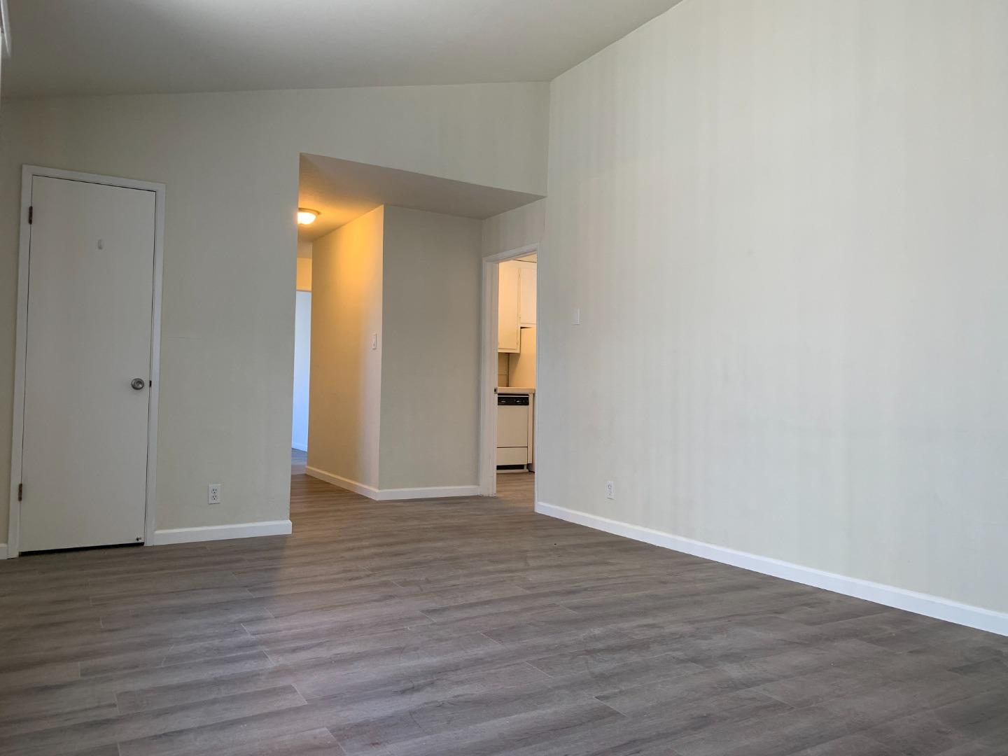 729 Highland Avenue, Unit 3 San Mateo, CA 94401 - Photo 3 of 18 a view of an empty room with wooden floor and closet