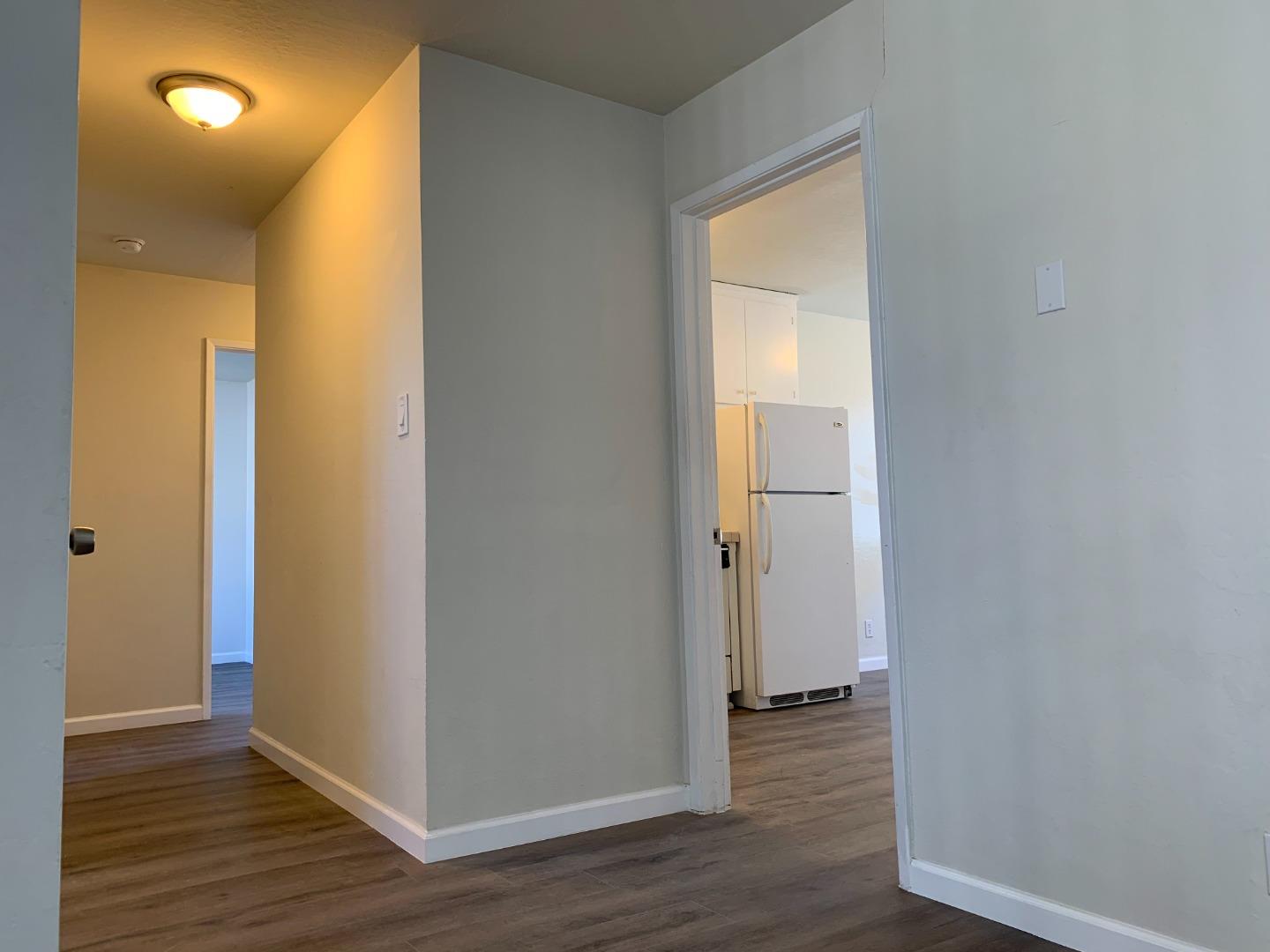 729 Highland Avenue, Unit 3 San Mateo, CA 94401 - Photo 7 of 18 a view of a hallway with wooden floor