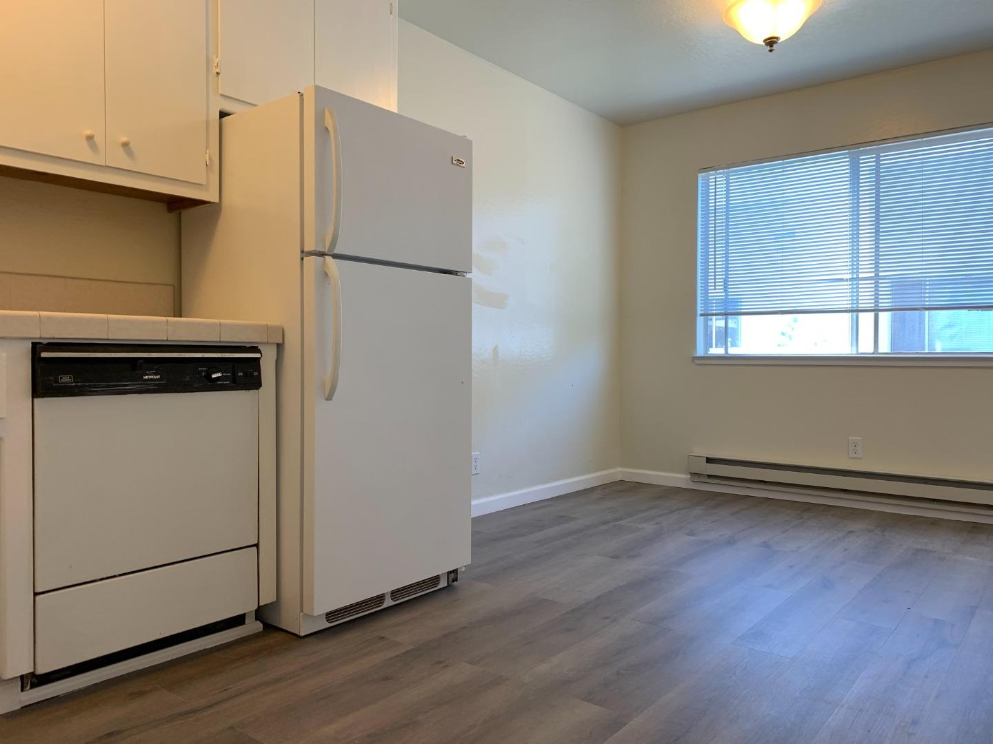 729 Highland Avenue, Unit 3 San Mateo, CA 94401 - Photo 8 of 18 a view of a refrigerator in kitchen and wooden floor