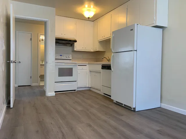 a kitchen with a refrigerator and a stove