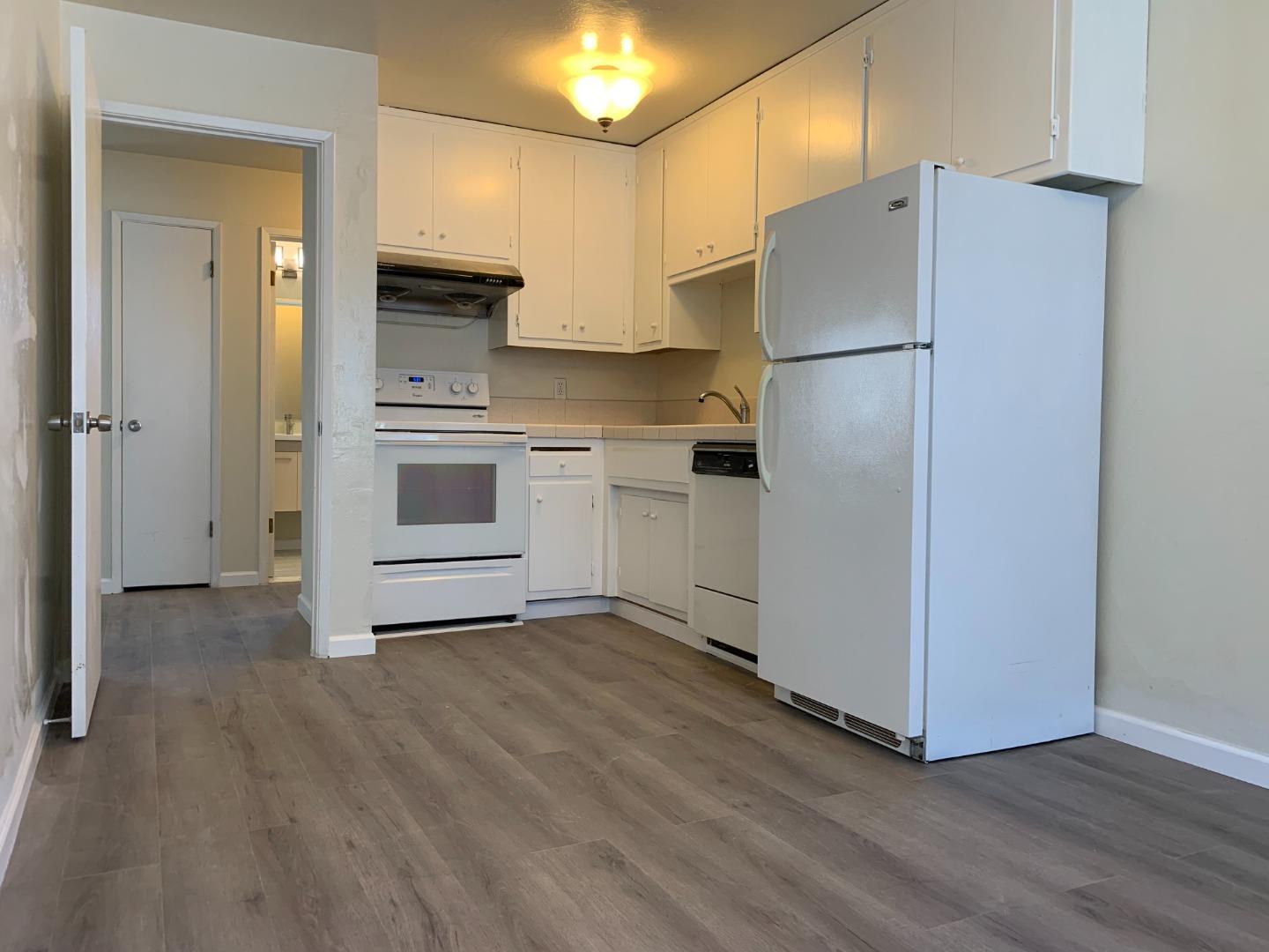 729 Highland Avenue, Unit 3 San Mateo, CA 94401 - Photo 9 of 18 a kitchen with a refrigerator and a stove