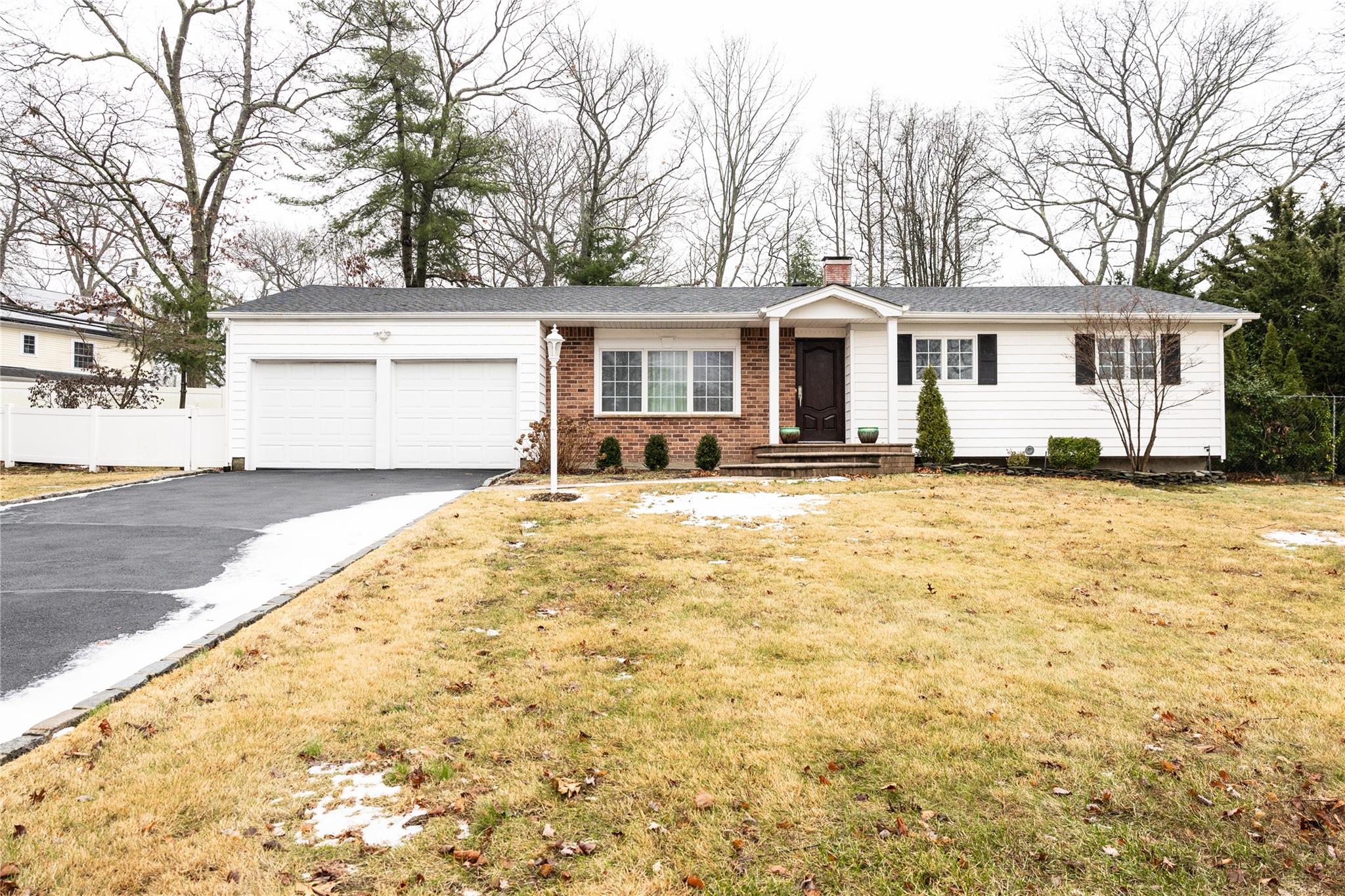 View of front of home with a front yard and a garage