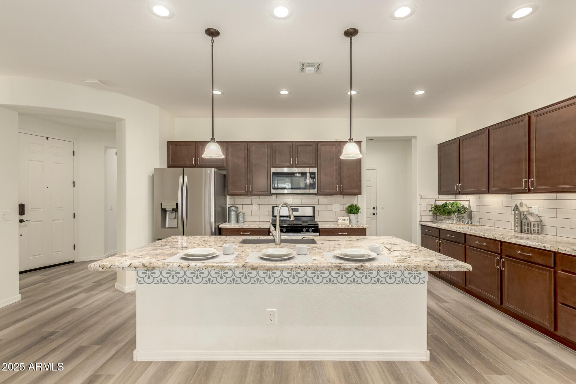 5660 South Colt Mesa, AZ 85212 - Photo 11 of 34 a kitchen with kitchen island granite countertop a sink a center island a stove a refrigerator and a center island