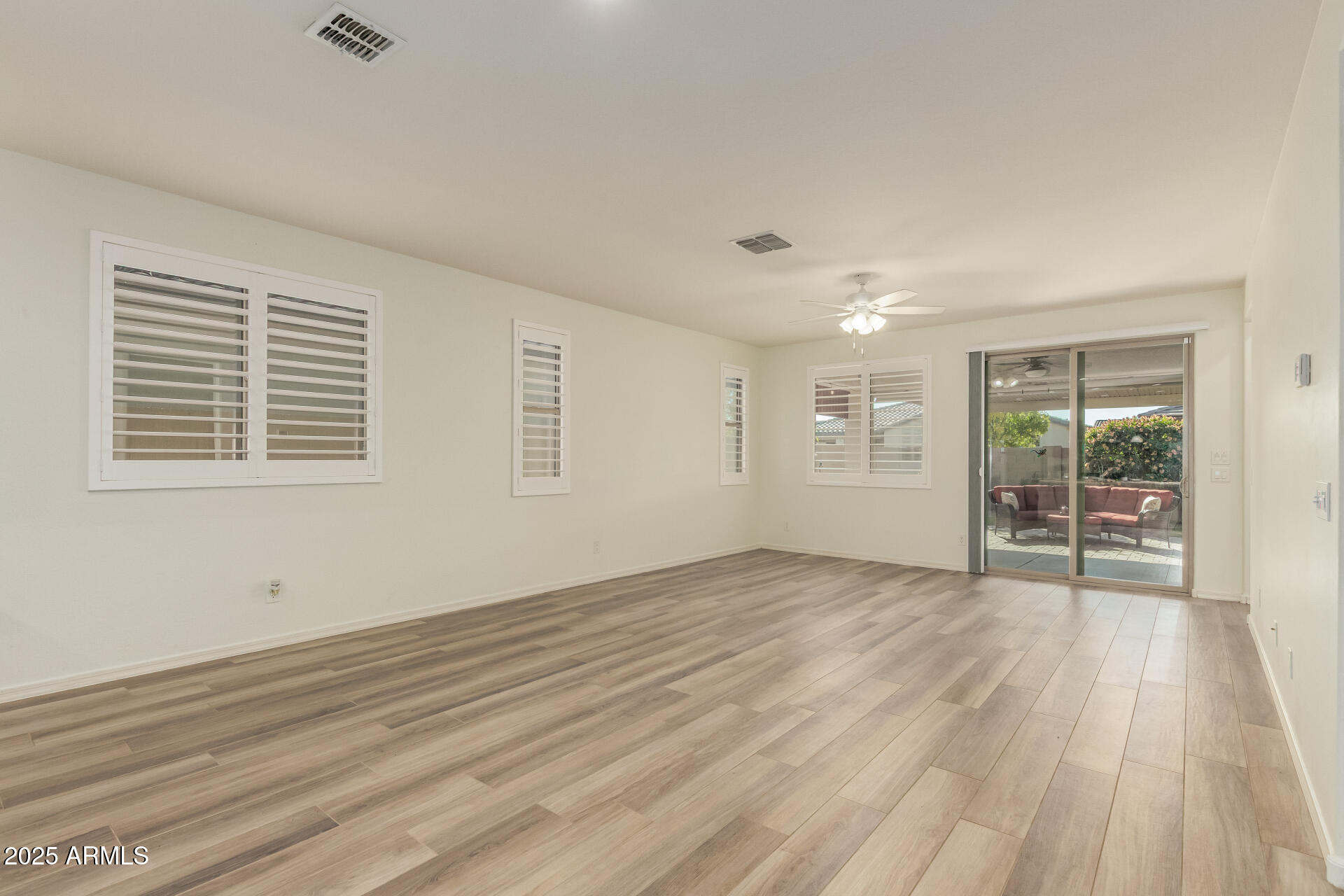 5660 South Colt Mesa, AZ 85212 - Photo 15 of 34 a view of an empty room with wooden floor and a window