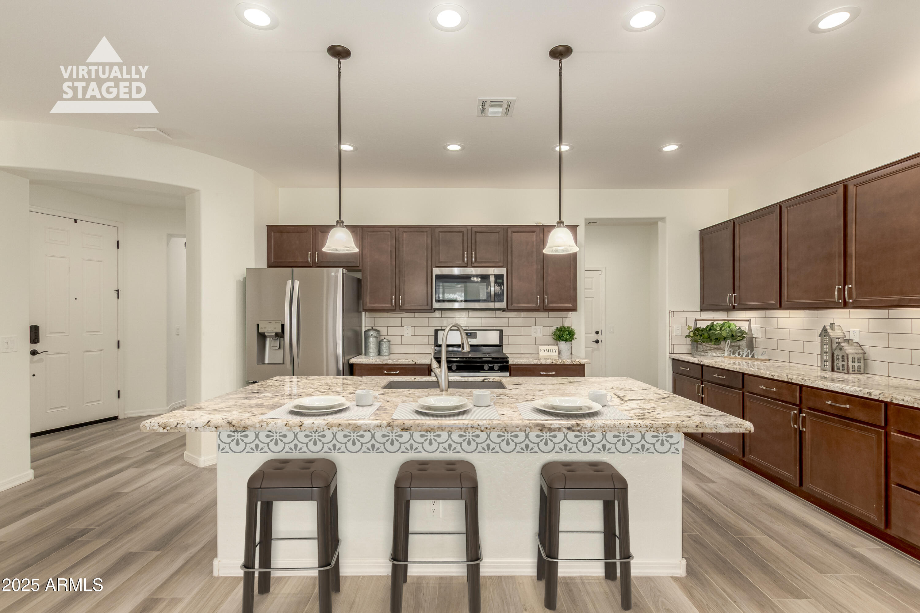 5660 South Colt Mesa, AZ 85212 - Photo 3 of 34 a kitchen with kitchen island granite countertop a dining table chairs sink and cabinets