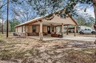 2078 Jeffcote Road Conroe, TX 77303 - Photo 6 of 19 Spacious covered porch, and surrounded by trees. Ample outdoor space for parking and relaxation. Ideal for those seeking a serene, country-like setting.