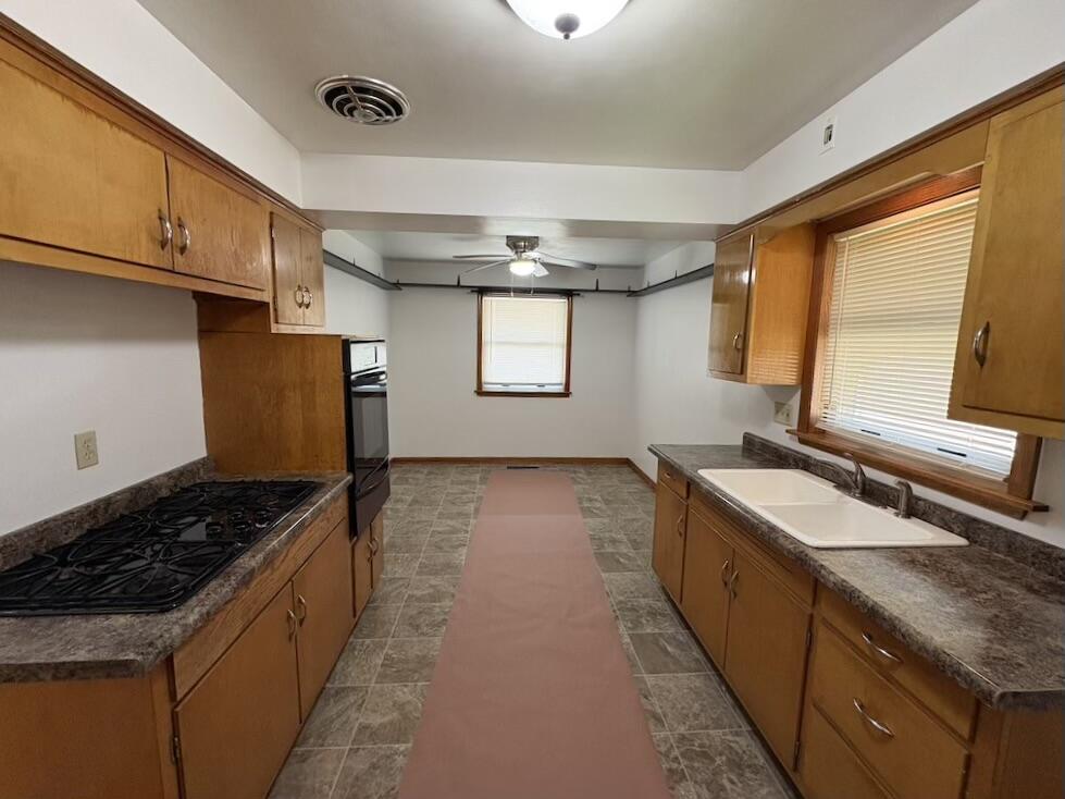 1915 169th Street Hammond, IN 46324 - Photo 12 of 19 a kitchen with granite countertop a sink stove and cabinets