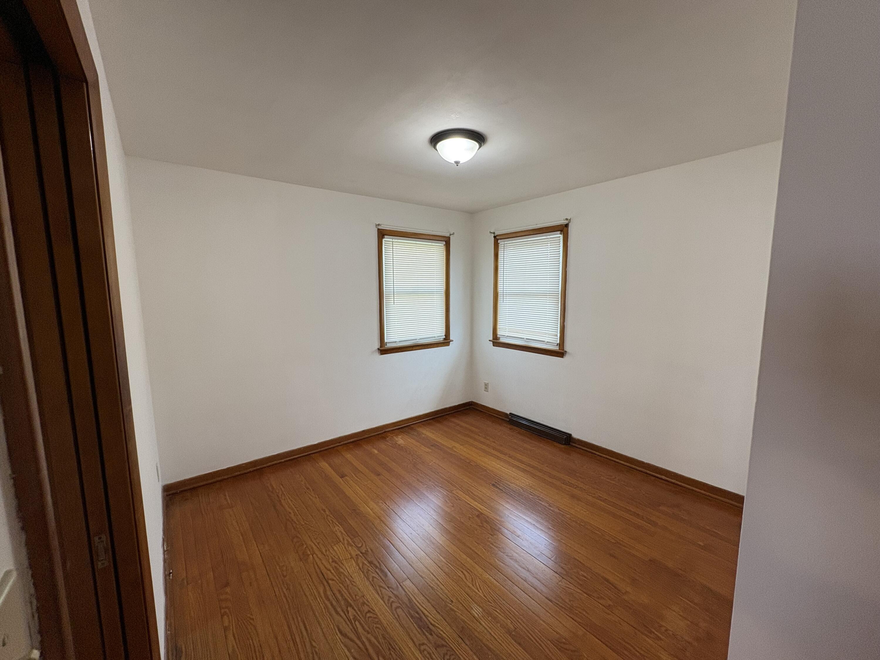 1915 169th Street Hammond, IN 46324 - Photo 15 of 19 an empty room with wooden floor and windows