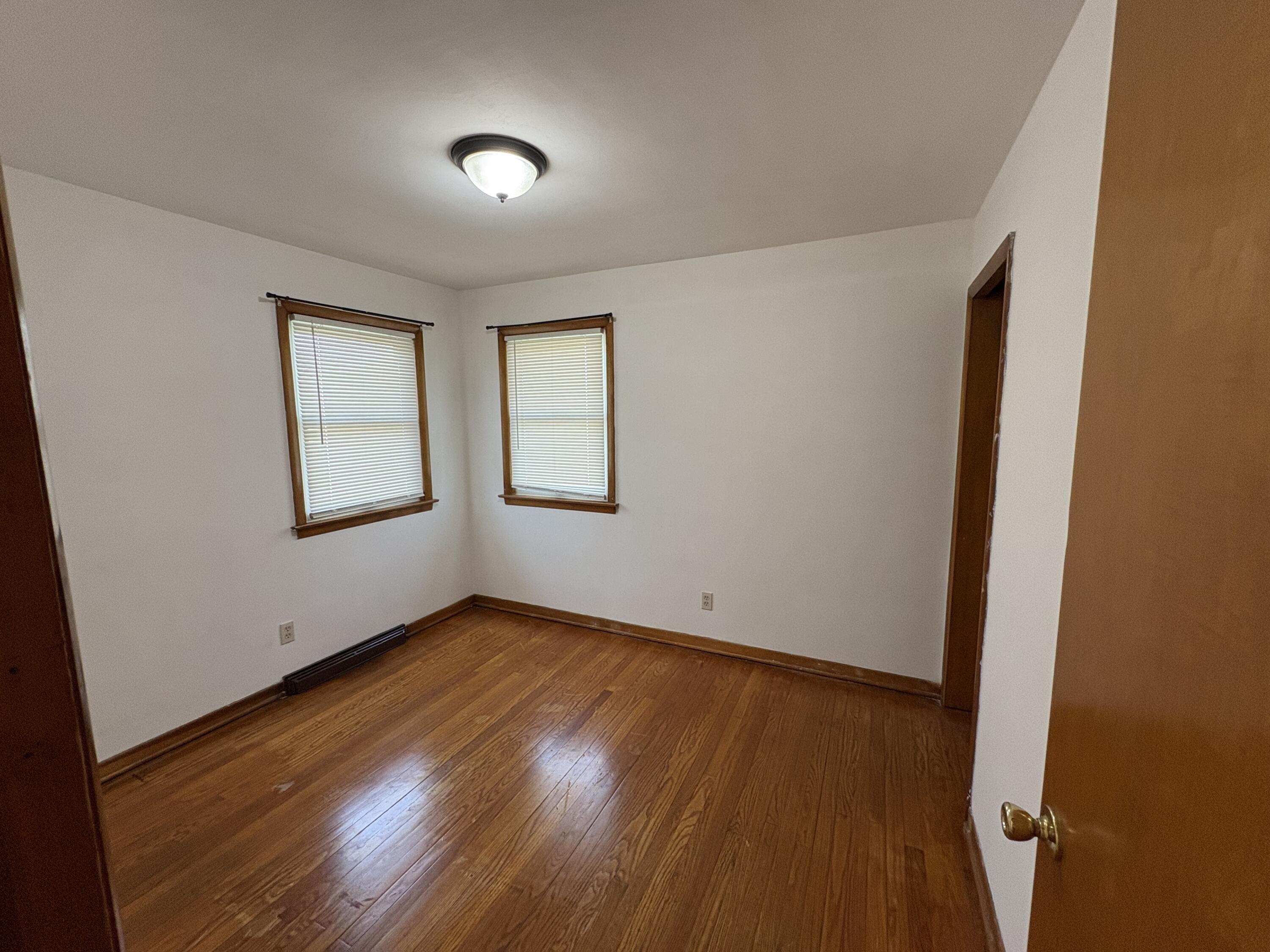 1915 169th Street Hammond, IN 46324 - Photo 16 of 19 an empty room with wooden floor and windows