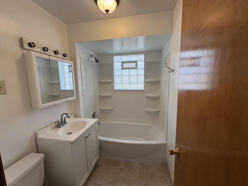 1915 169th Street Hammond, IN 46324 - Photo 17 of 19 a white bath tub sitting next to a white sink and vanity