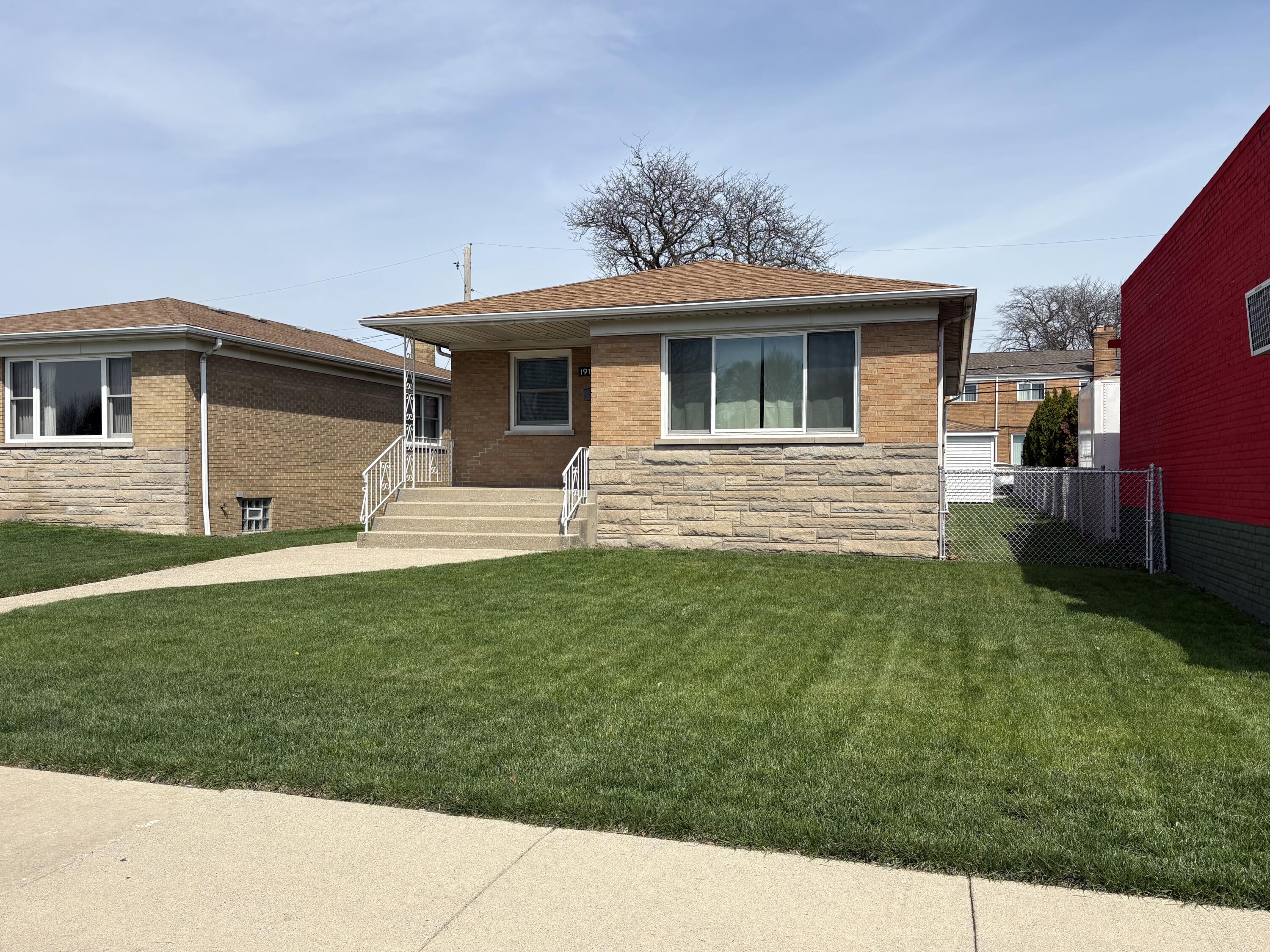 1915 169th Street Hammond, IN 46324 - Photo 2 of 19 a front view of a house with a yard