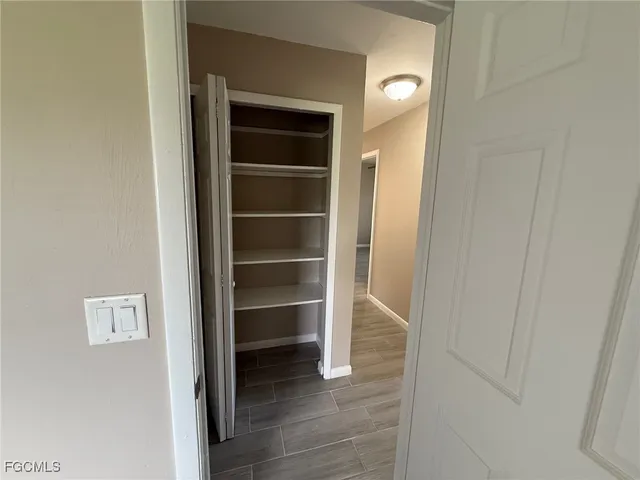 a view of walk in closet with empty racks