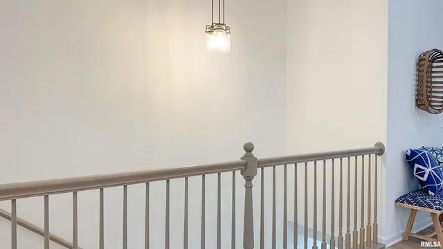 a view of a hallway with wooden floor and a window