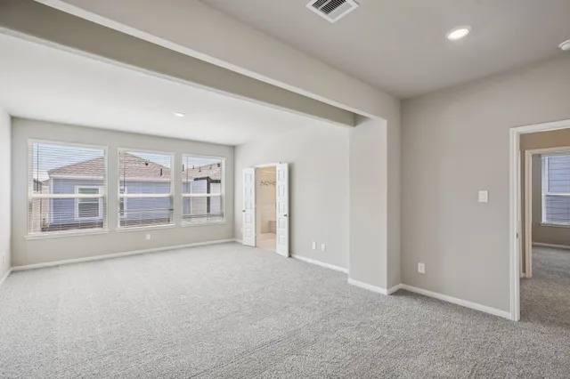 an empty room with a empty space and windows