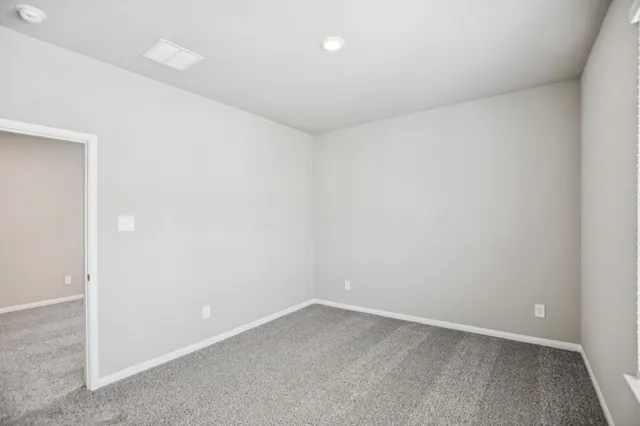 an empty room with closet area