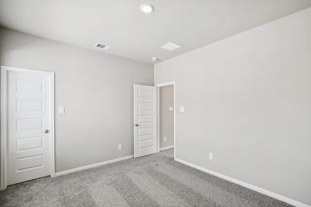 an empty room with windows and closet