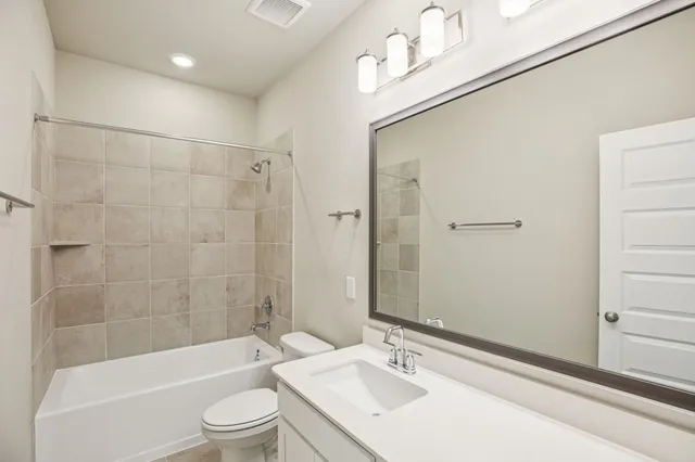 a bathroom with a bathtub and a sink