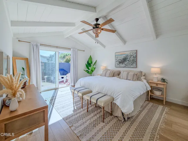 a bedroom with a bed lamps and window