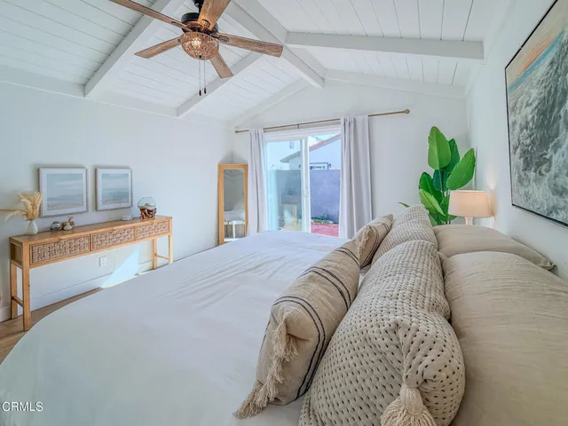 a bedroom with a bed and ceiling fan