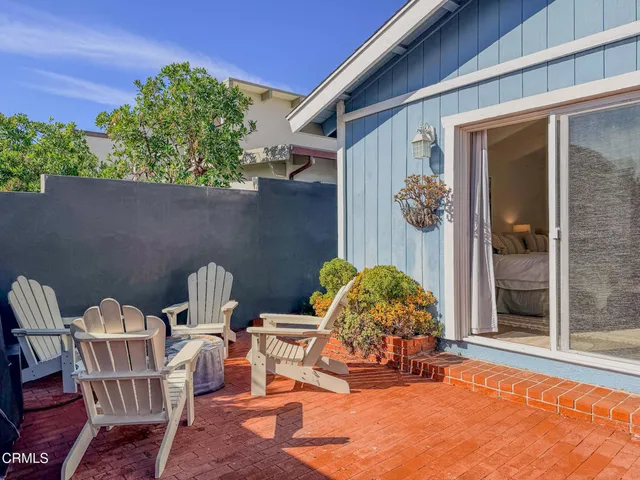 a view of a patio with table and chairs and potted plants