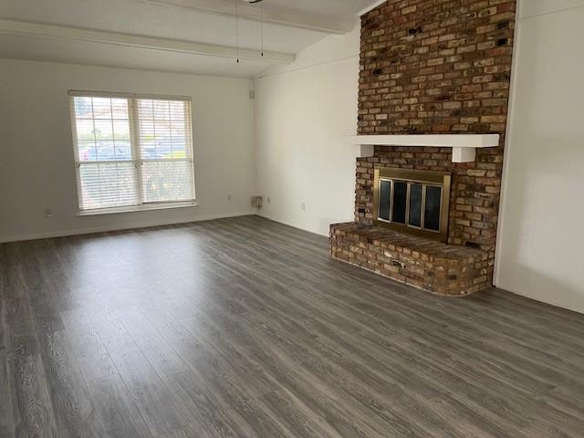 1022 Misty Way Garland, TX 75040 - Photo 3 of 15 an empty room with wooden floor a fireplace and windows