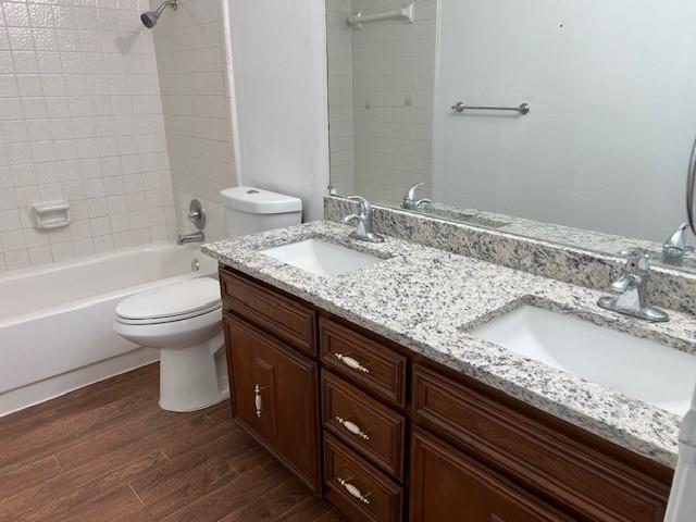 1022 Misty Way Garland, TX 75040 - Photo 4 of 15 a bathroom with a granite countertop toilet a sink and a bathtub