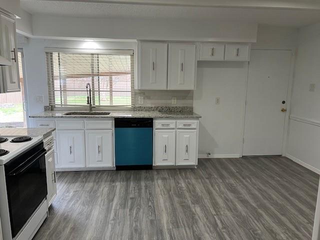 1022 Misty Way Garland, TX 75040 - Photo 10 of 15 a kitchen with a stove wooden floors and white cabinets