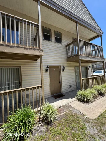 a view of a house with plants and porch