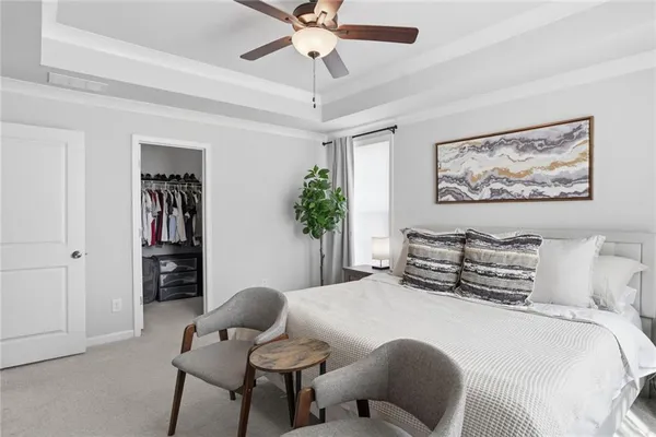 a view of walk in closet with clothes