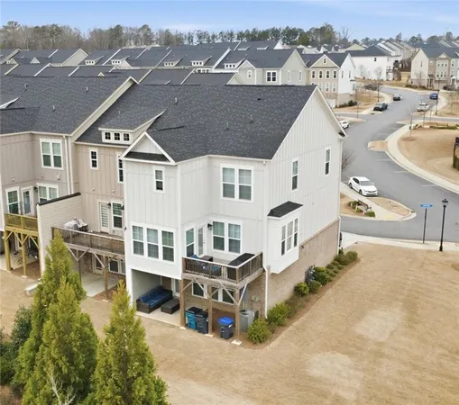 an aerial view of multiple houses with a yard