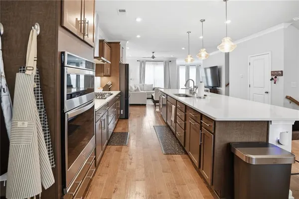 a kitchen with kitchen island granite countertop a sink stove and refrigerator