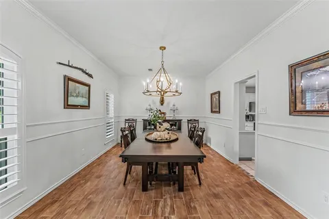 a dining room with furniture a rug and a chandelier