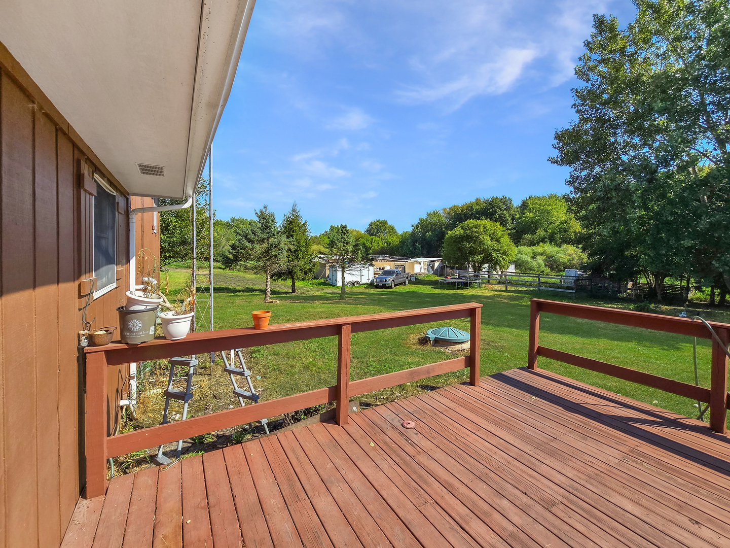934 Vilmin Road Plano, IL 60545 - Photo 21 of 24 a view of a deck with two chairs and a table
