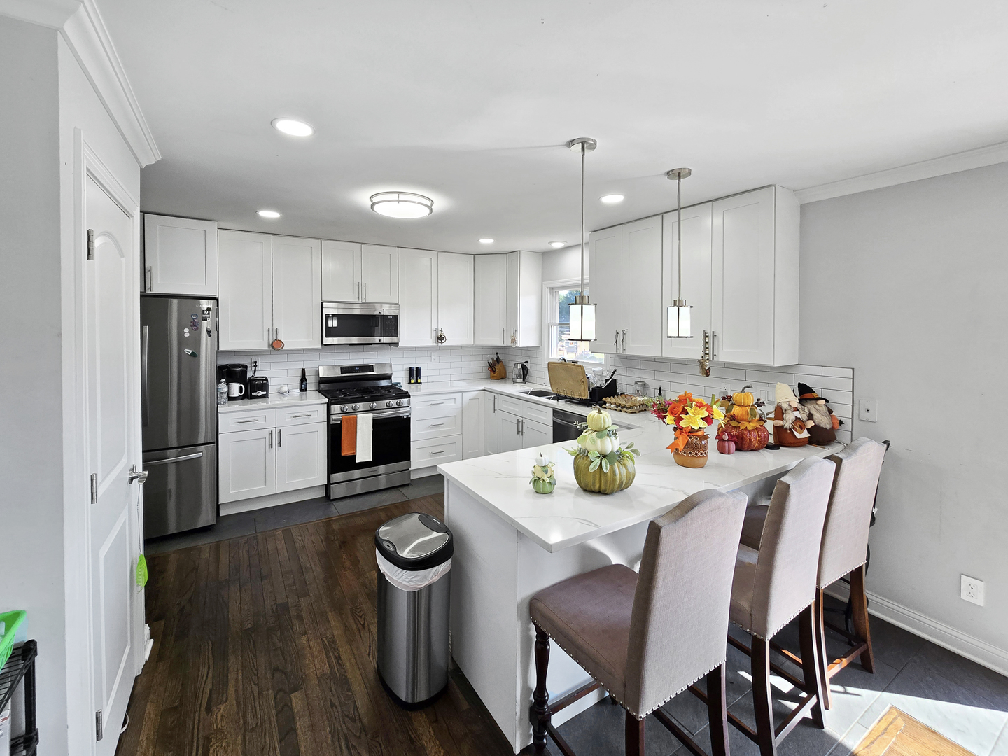 934 Vilmin Road Plano, IL 60545 - Photo 4 of 24 a kitchen with refrigerator and white cabinets
