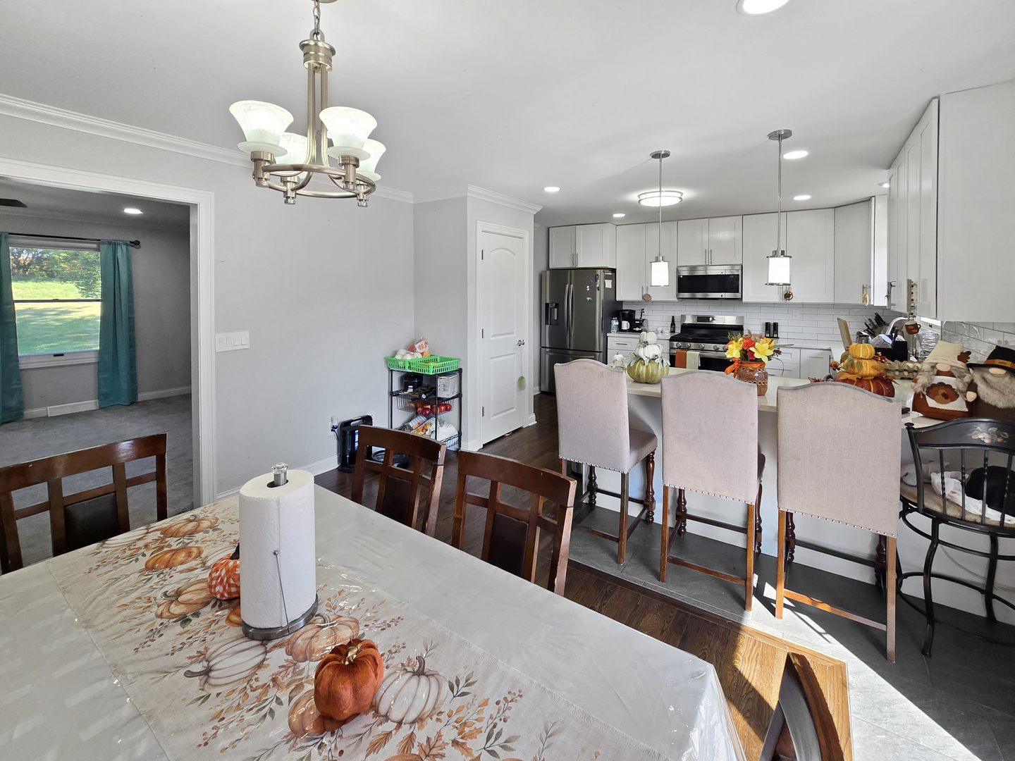 934 Vilmin Road Plano, IL 60545 - Photo 6 of 24 a view of a dining room with furniture and wooden floor