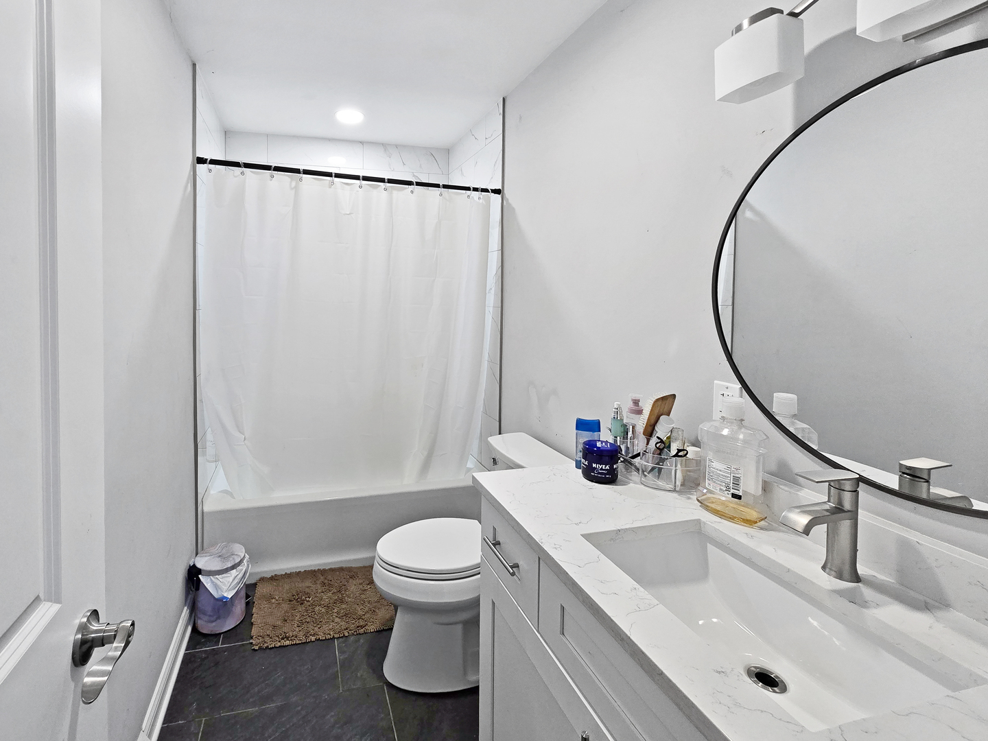 934 Vilmin Road Plano, IL 60545 - Photo 9 of 24 a bathroom with a sink a toilet and a mirror