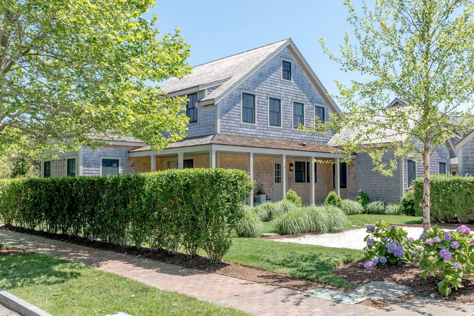 12 Wood Lily Road Nantucket, MA 02554 - Photo 1 of 70 a front view of a house with a garden