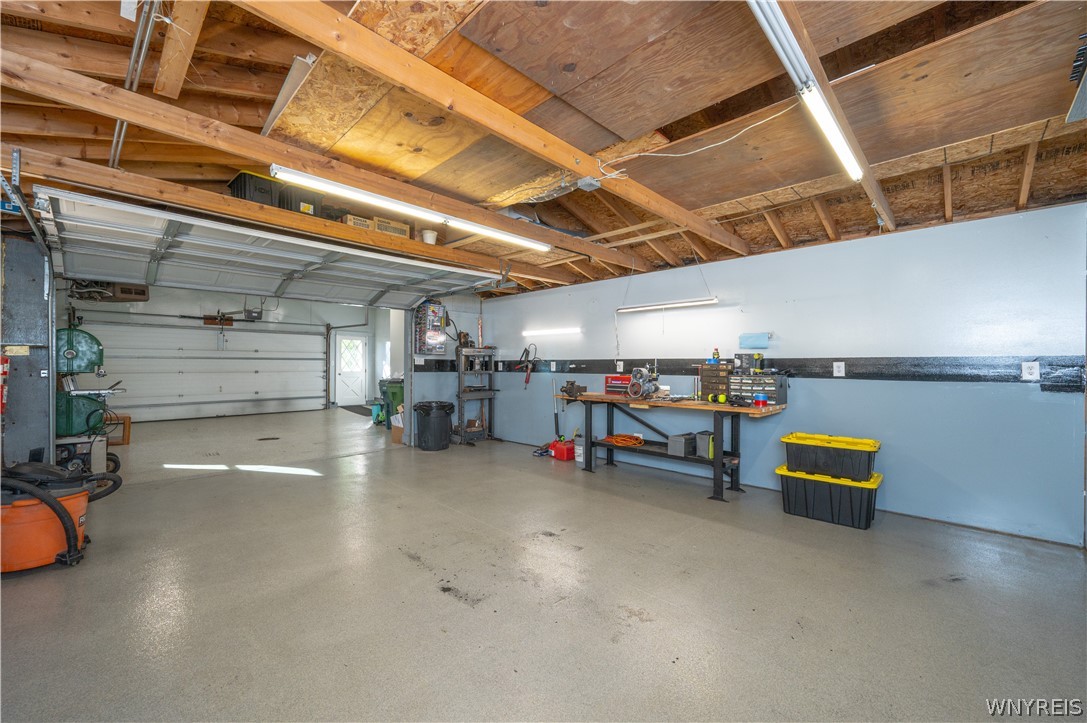 6463 Ward Road Sanborn, NY 14132 - Photo 39 of 49 Exposed wooden rafters and smooth concrete flooring define this highly functional workspace.