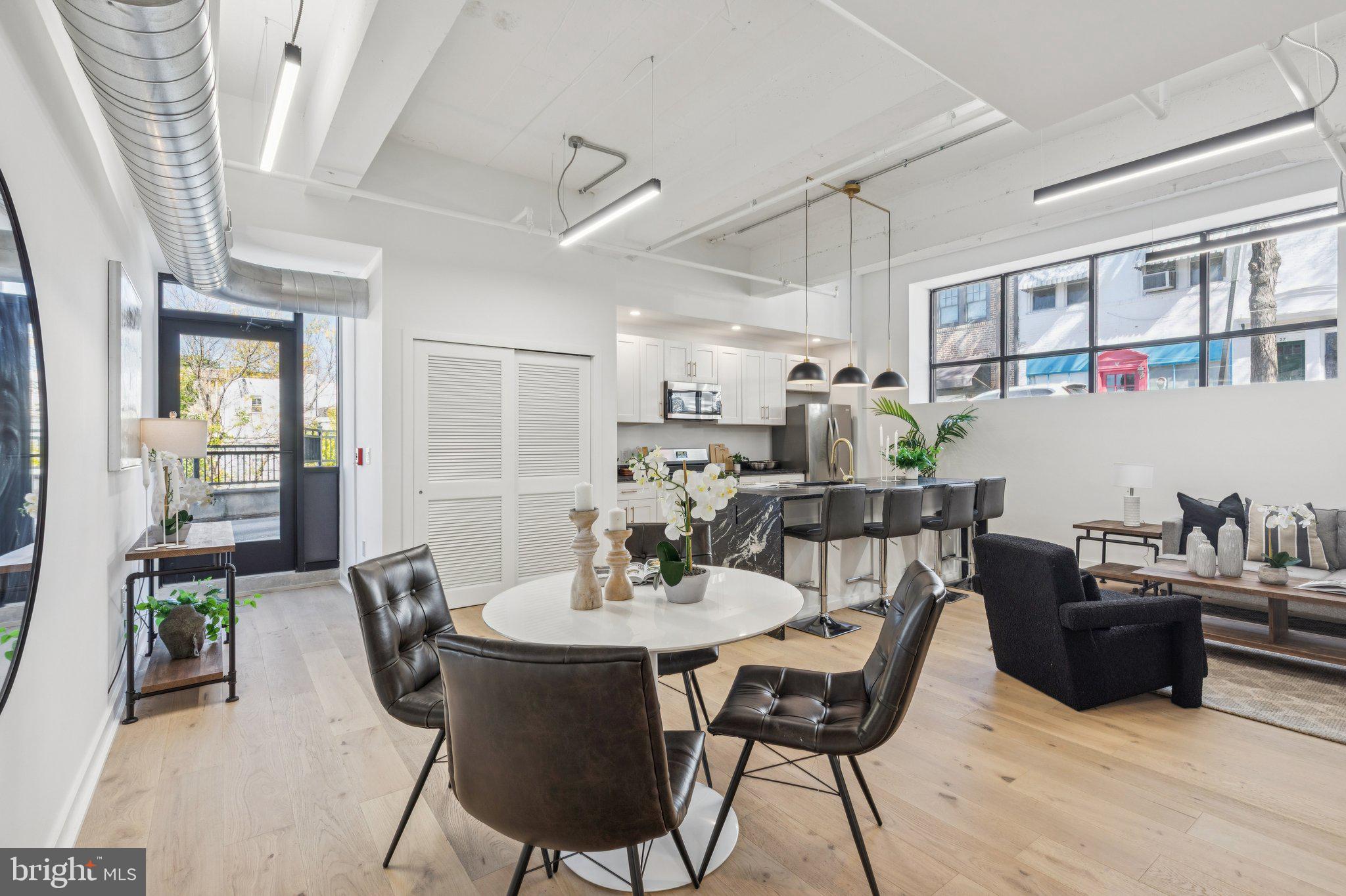 a view of a dining room with furniture and a potted plant