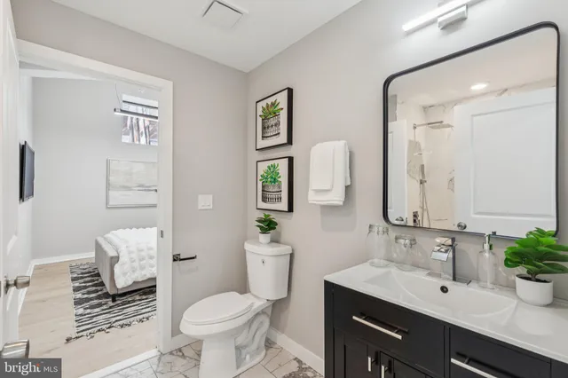 a bathroom with a toilet sink and mirror