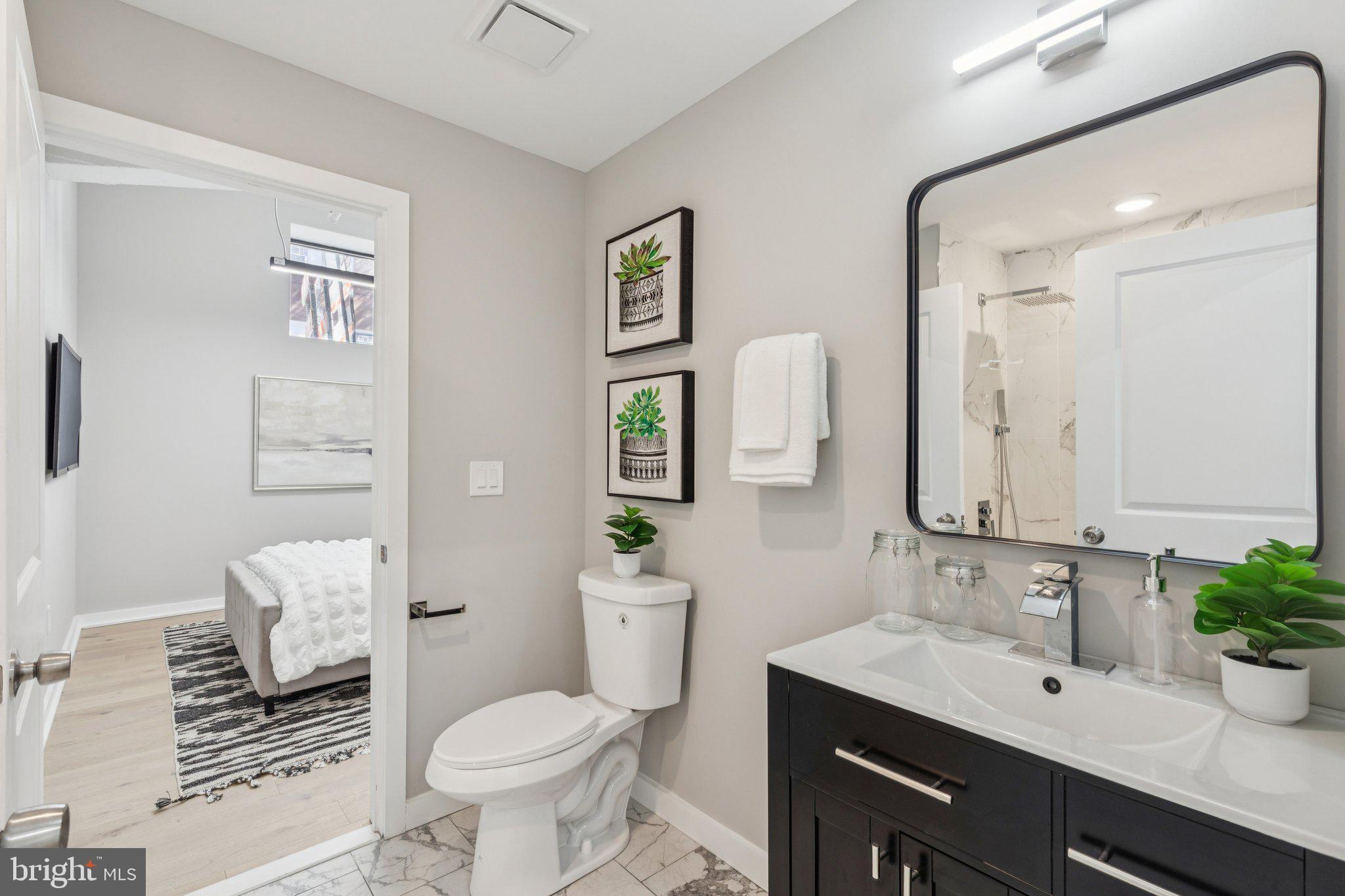 36 North Narberth Avenue, Unit 1C Narberth, PA 19072 - Photo 11 of 36 a bathroom with a toilet sink and mirror