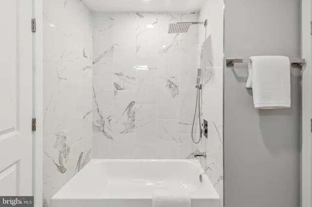 a bathroom with a bathtub and shower