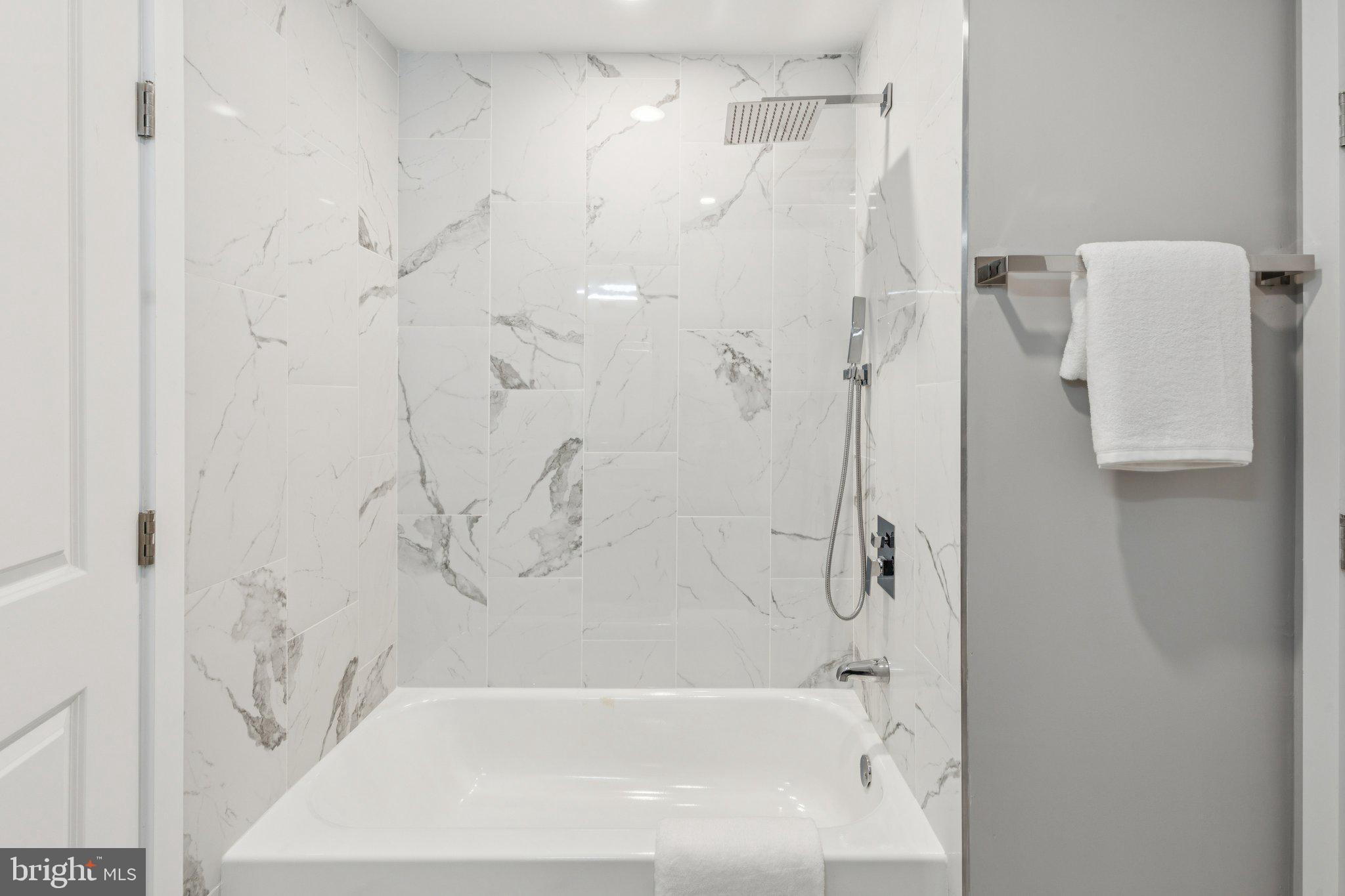 36 North Narberth Avenue, Unit 1C Narberth, PA 19072 - Photo 12 of 36 a bathroom with a bathtub and shower