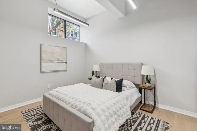 a bedroom with a bed and a lamp on table