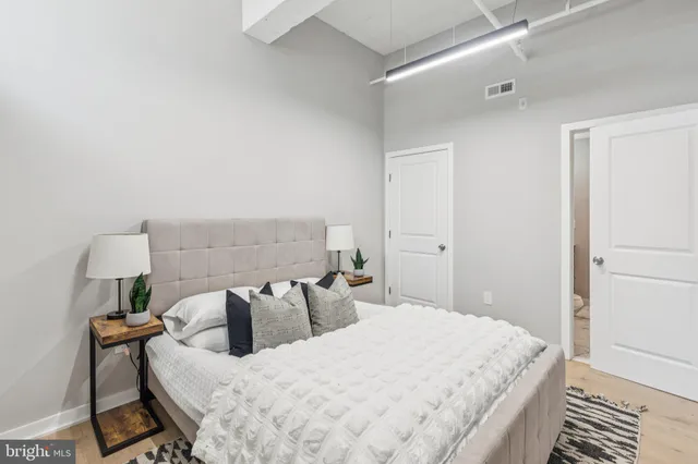 a bedroom with bed and a night stand