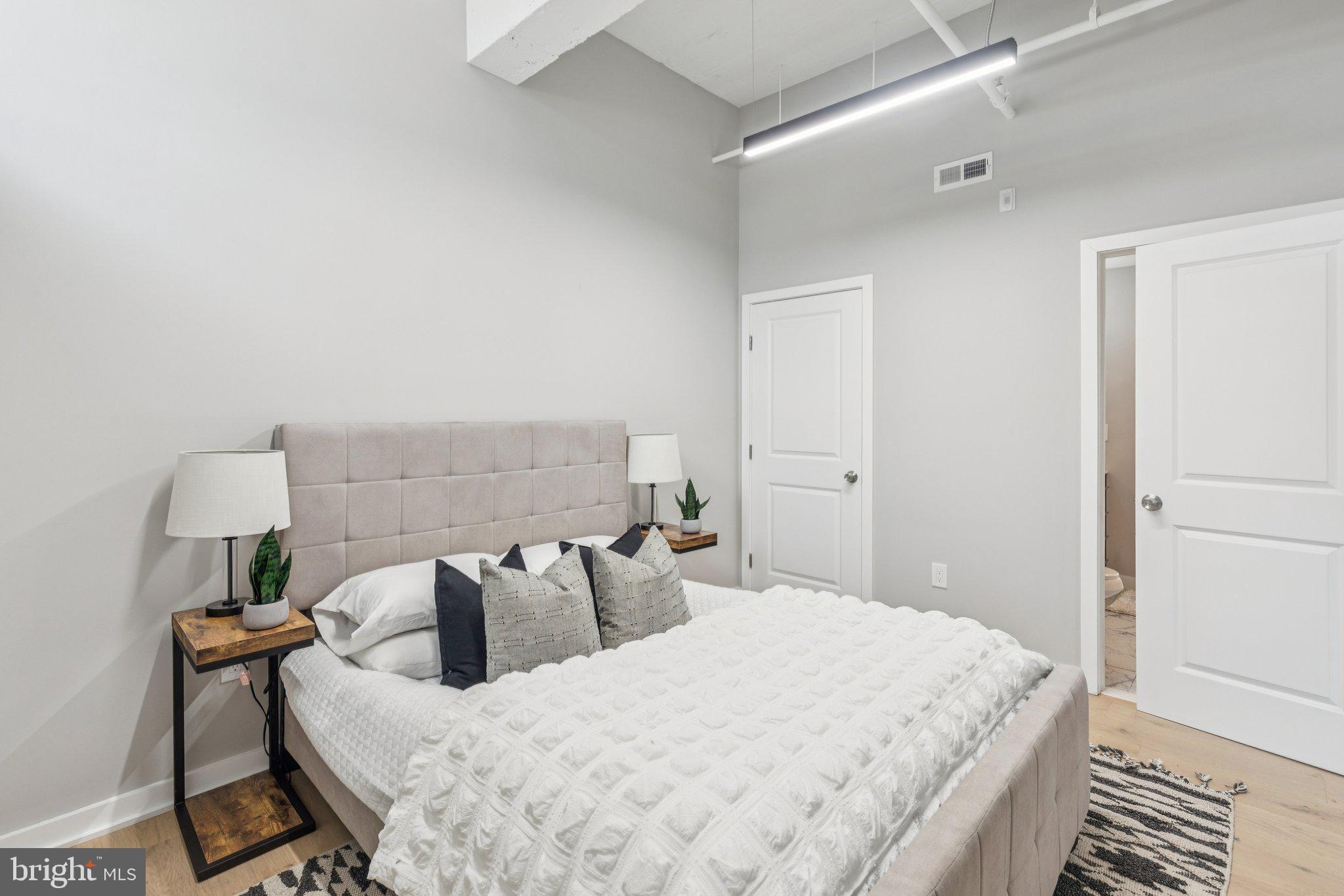 36 North Narberth Avenue, Unit 1C Narberth, PA 19072 - Photo 14 of 36 a bedroom with bed and a night stand