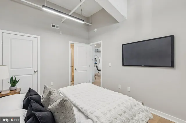 a bedroom with a bed and a flat screen tv