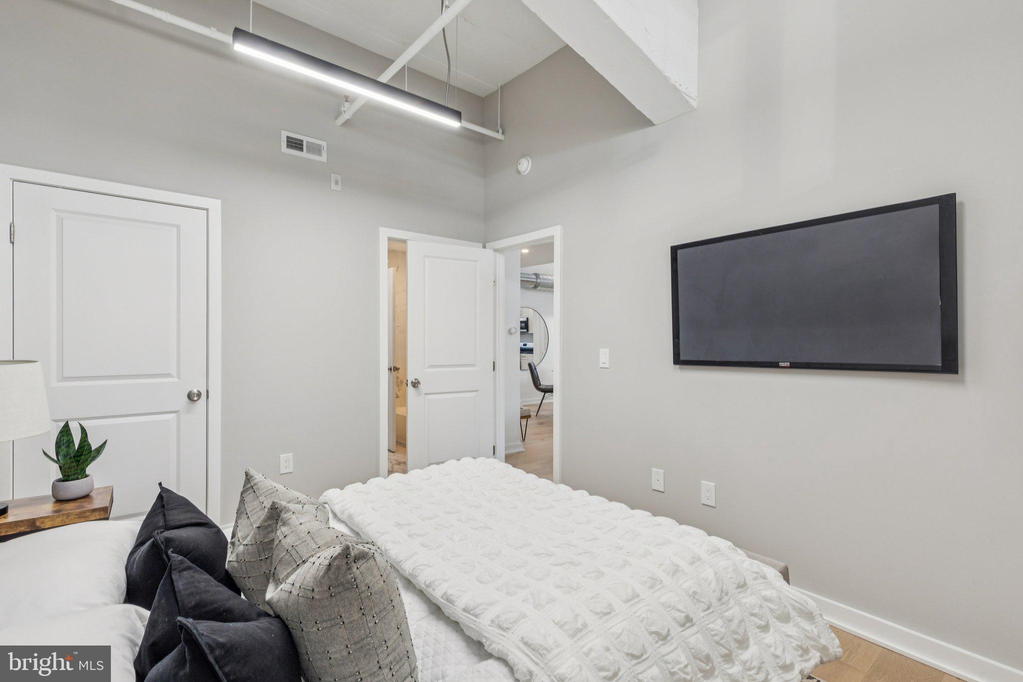 36 North Narberth Avenue, Unit 1C Narberth, PA 19072 - Photo 15 of 36 a bedroom with a bed and a flat screen tv